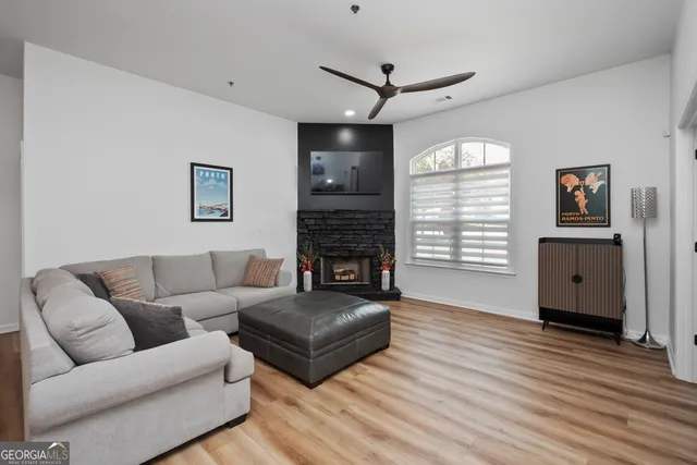 a living room with furniture a window and a fireplace