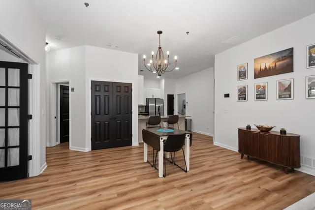 a view of a dining room with furniture and chandelier