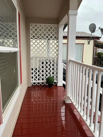 a view of a porch with wooden floor