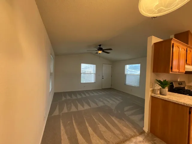 a view of a kitchen with a sink and cabinets