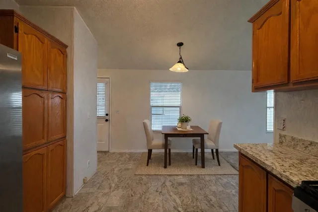 a view of kitchen with furniture wooden floor and window