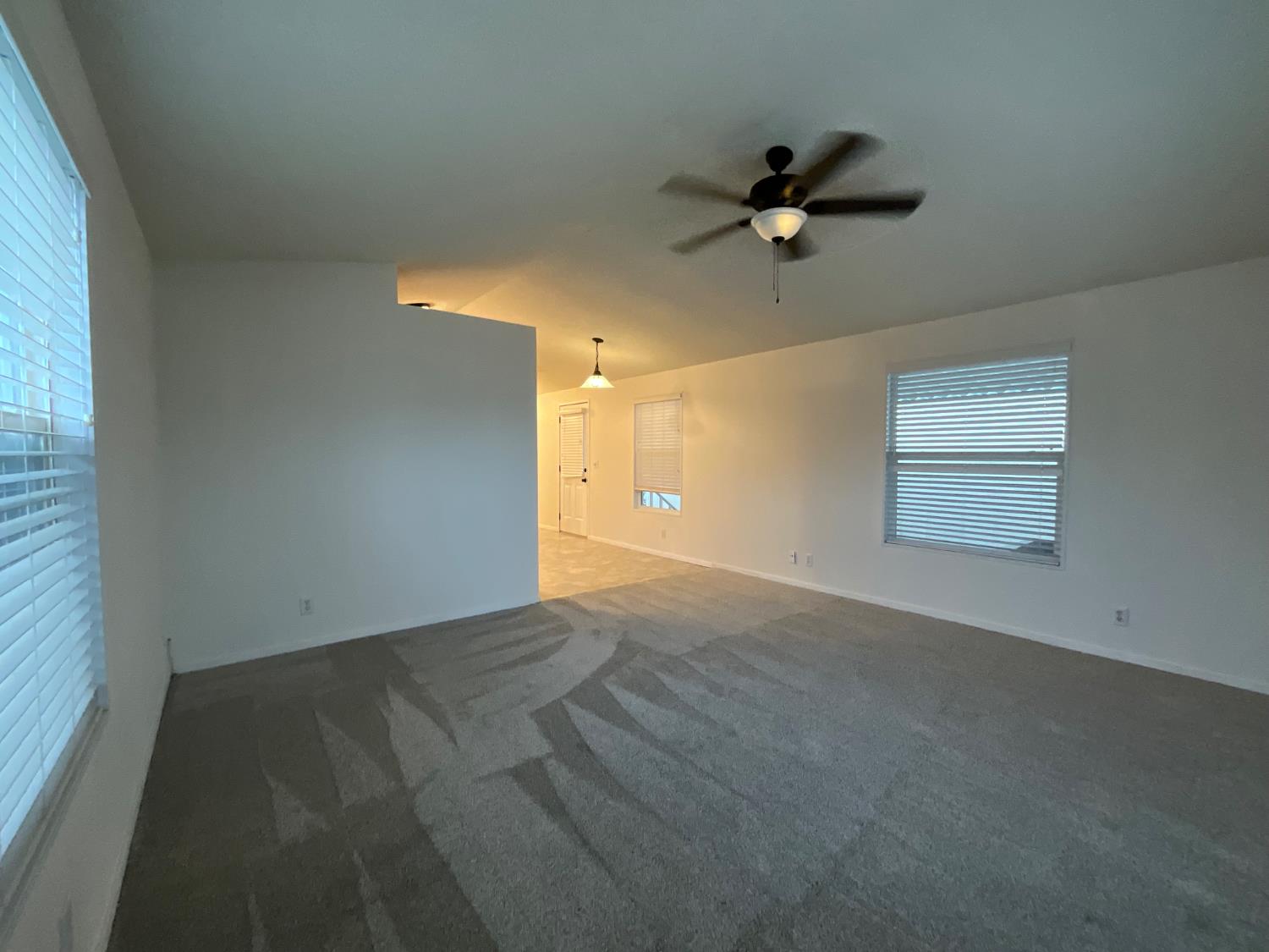 26 Golden Inn Way Rancho Cordova, CA 95670 - Photo 20 of 27 en empty room with windows and ceiling fan