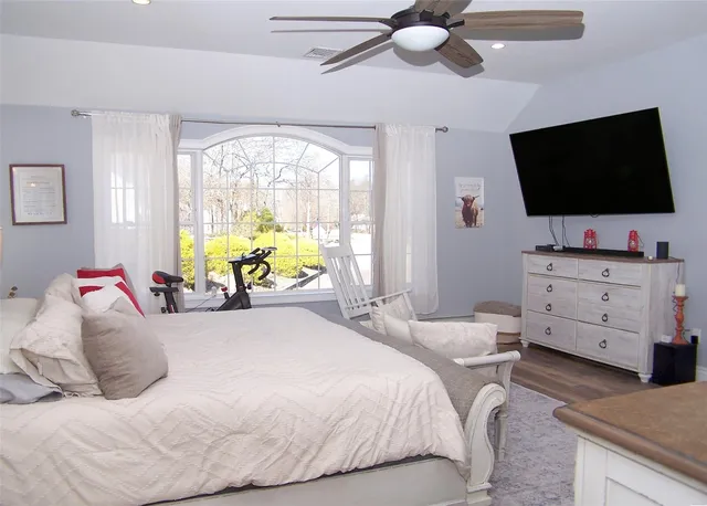a bedroom with a bed and flat screen tv