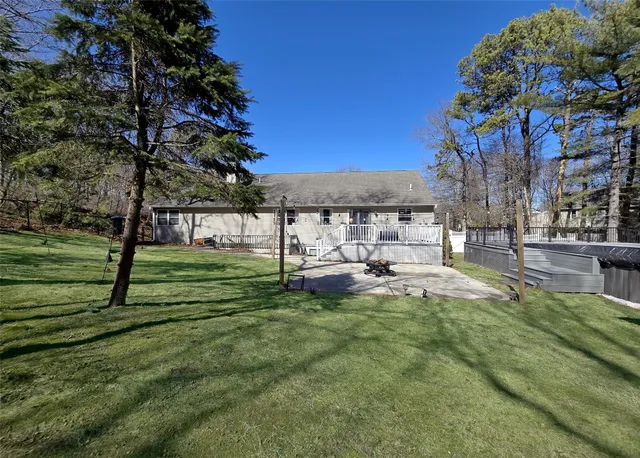 a view of yard with swimming pool and green space