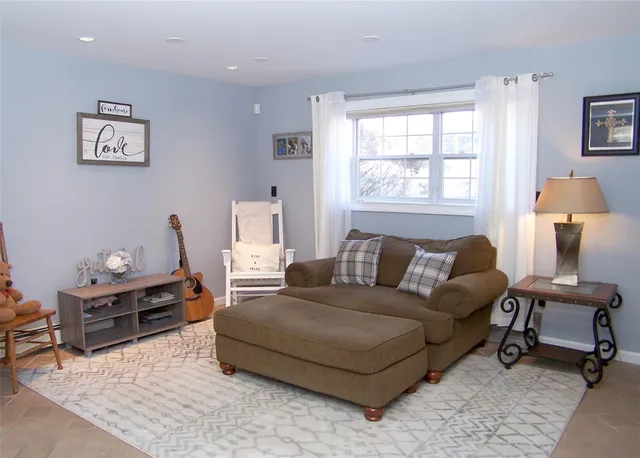 a living room with furniture and a window