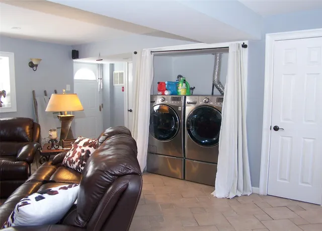 a living room with furniture and a lamp