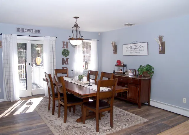 a view of a dining room with furniture window and wooden floor