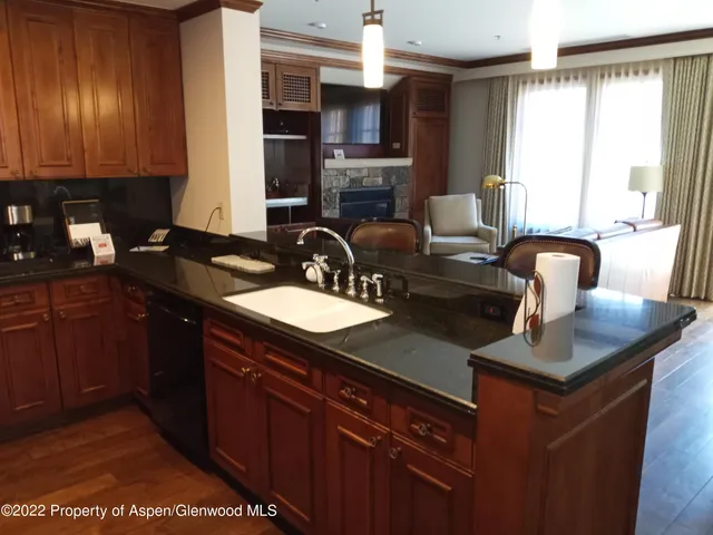 a kitchen with granite countertop a sink cabinets and window