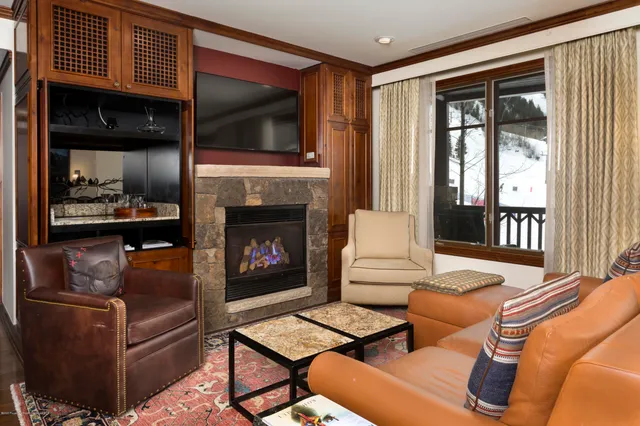 a living room with furniture fireplace and flat screen tv