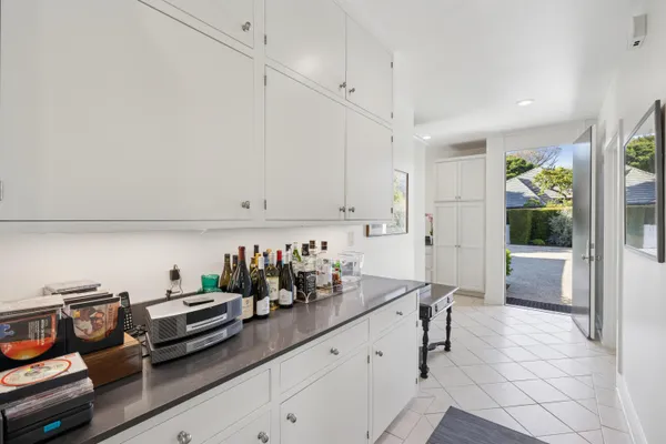 a kitchen with sink cabinets and potted plant