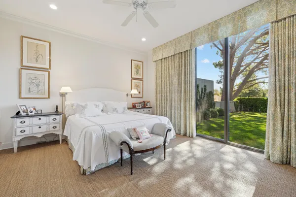 a spacious bedroom with a bed and a large window