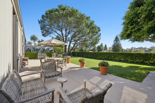 a view of a patio with couches and table and chairs and garden