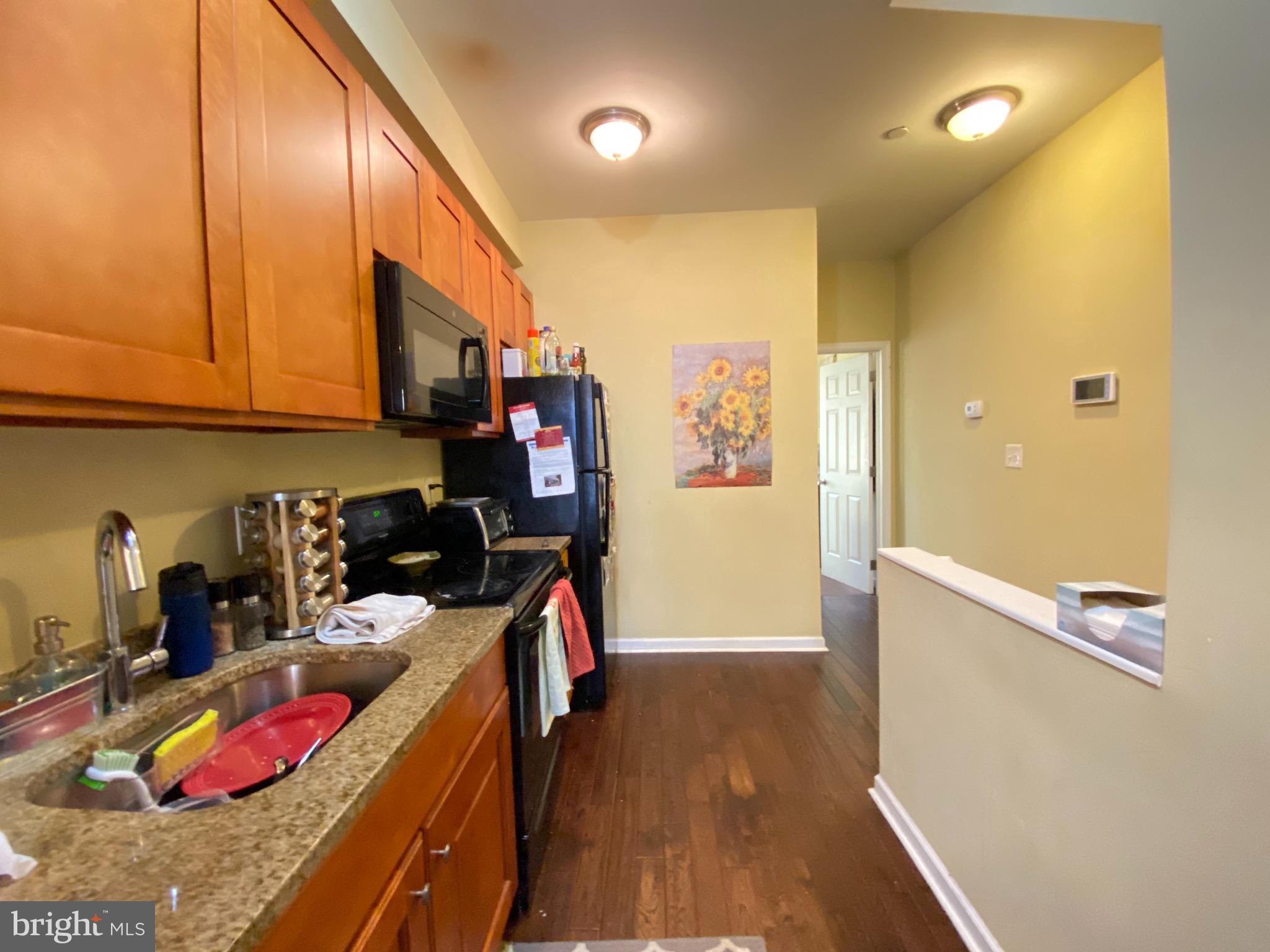 1618 Page Street, Unit B Philadelphia, PA 19121 - Photo 6 of 17 a view of a kitchen with fridge and workspace
