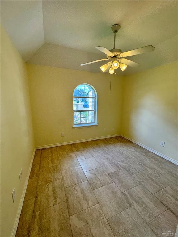 2207 Turtle Court Mission, TX 78572 - Photo 15 of 22 en empty room with windows and chandelier fan