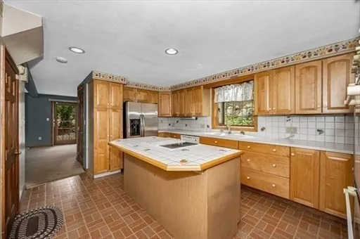 a kitchen with a sink a counter top space and stainless steel appliances