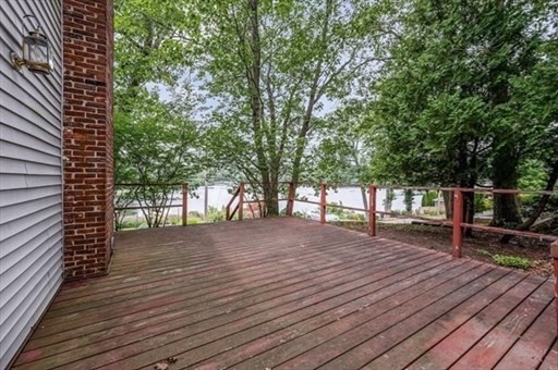 15 Shore Road Saugus, MA 01906 - Photo 8 of 15 a wooden deck with trees in front of it