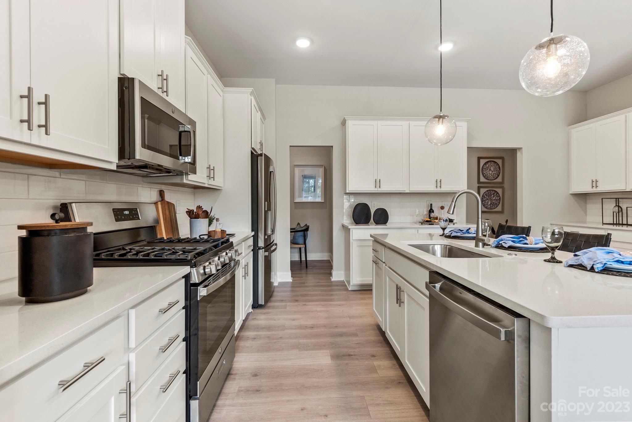8958 Morning Mist Road Harrisburg, NC 28215 - Photo 14 of 28 a kitchen with stainless steel appliances granite countertop a stove a sink and a refrigerator