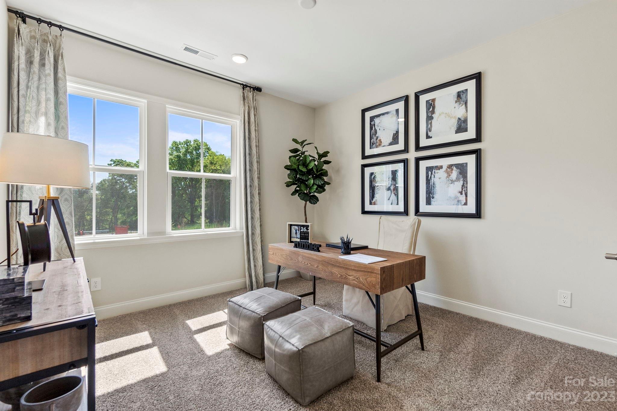 8958 Morning Mist Road Harrisburg, NC 28215 - Photo 26 of 28 a living room with furniture and a window