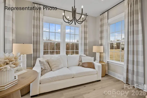 a living room with furniture and a chandelier