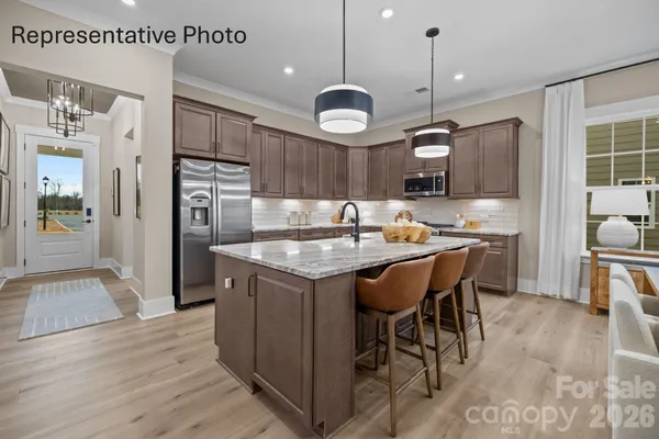 a large kitchen with a table and chairs