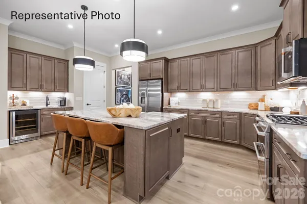 a kitchen with a table chairs sink and cabinets
