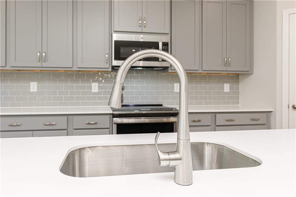 326 Cavalier Lane Acworth, GA 30102 - Photo 12 of 64 a kitchen with granite countertop a sink and granite counter tops