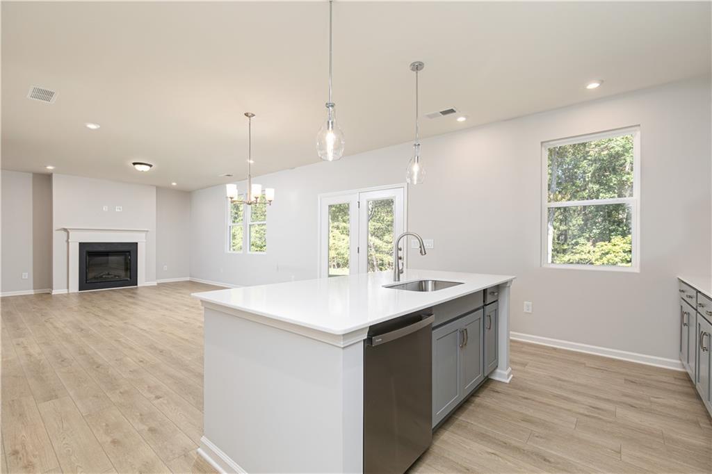 326 Cavalier Lane Acworth, GA 30102 - Photo 15 of 64 a kitchen with a sink chandelier and wooden floor