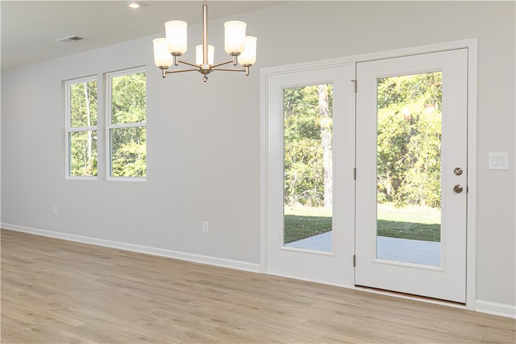 326 Cavalier Lane Acworth, GA 30102 - Photo 16 of 64 a view of an empty room with wooden floor and a window