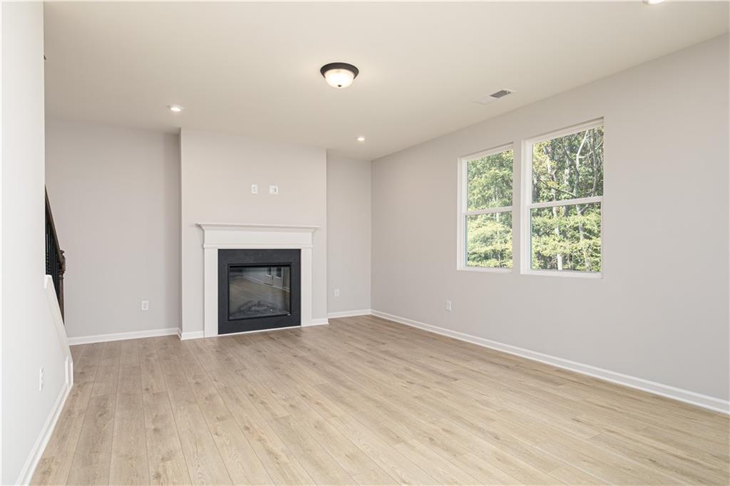 326 Cavalier Lane Acworth, GA 30102 - Photo 18 of 64 an empty room with windows and a fireplace