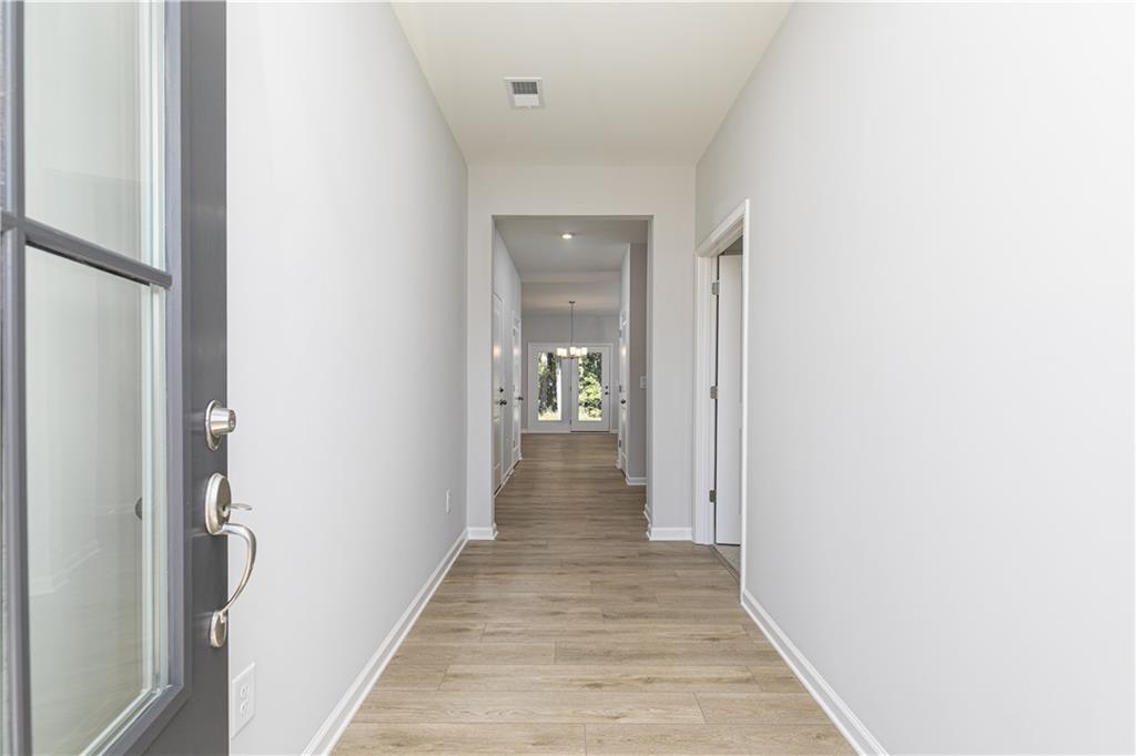 326 Cavalier Lane Acworth, GA 30102 - Photo 2 of 64 a view of a hallway with wooden floor