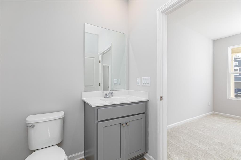 326 Cavalier Lane Acworth, GA 30102 - Photo 8 of 64 a bathroom with a toilet a sink and mirror