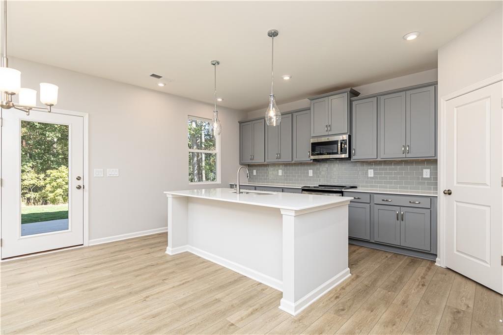 326 Cavalier Lane Acworth, GA 30102 - Photo 9 of 64 a kitchen with stainless steel appliances granite countertop a stove top oven a sink dishwasher and a refrigerator