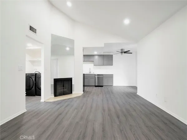 a view of a kitchen with wooden floor and a sink