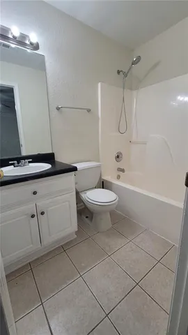 a bathroom with a granite countertop sink a toilet and a mirror