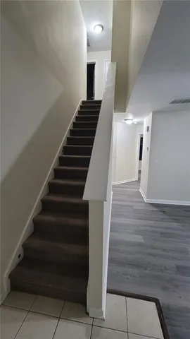 a view of entryway and hall with wooden floor