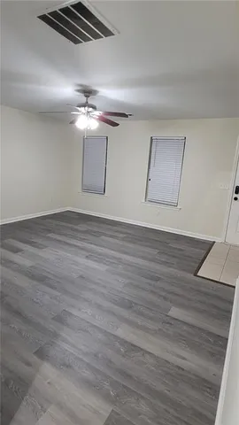 a view of a room with wooden floor