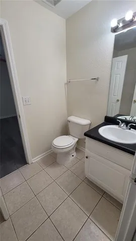 a white toilet sitting next to a bathroom sink