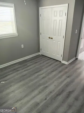 a bathroom with a toilet a sink and a window