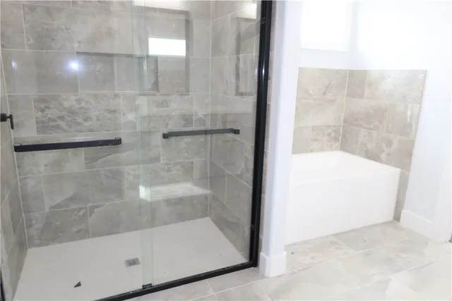 an empty room with a window and wooden floor