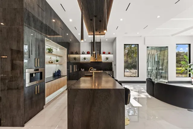 a kitchen with stainless steel appliances granite countertop a refrigerator and a stove