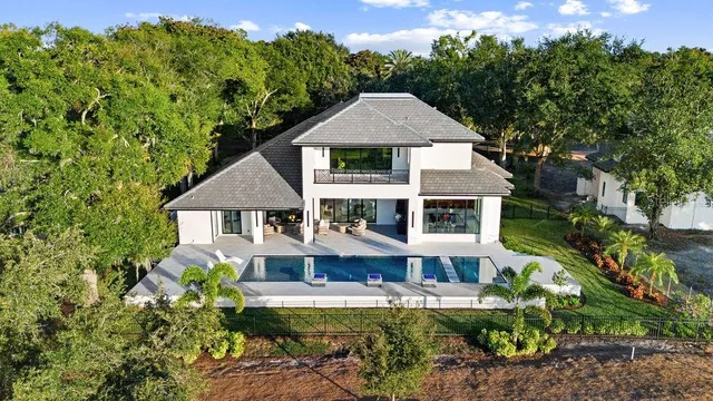 a front view of a house with yard and green space