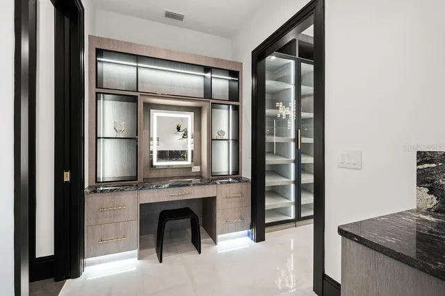 a bathroom with a granite countertop sink and shower