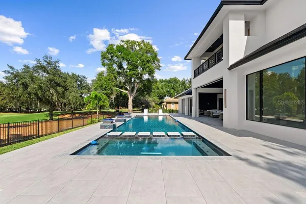 a front view of a house with a yard and trees