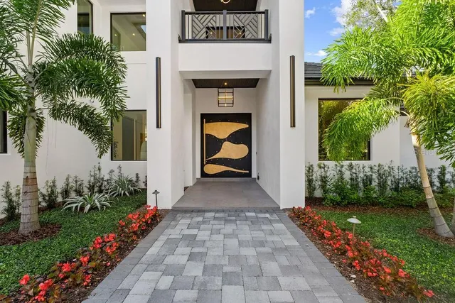 a kitchen with stainless steel appliances granite countertop a refrigerator a stove and a sink with wooden floor