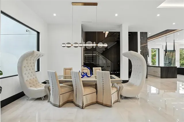 a living room with patio furniture and a chandelier