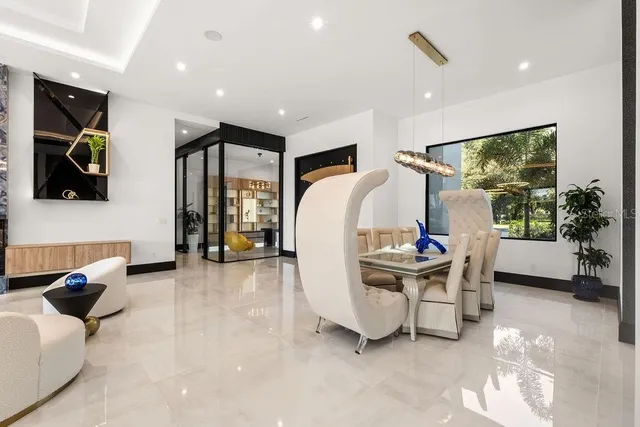 a living room with fireplace furniture and a chandelier