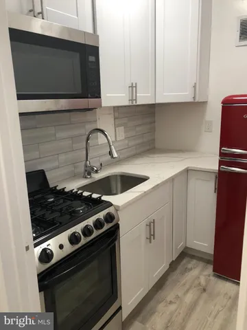 a kitchen with a stove and a microwave