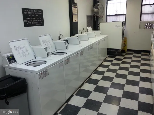 a kitchen with a sink a refrigerator and a black cabinets
