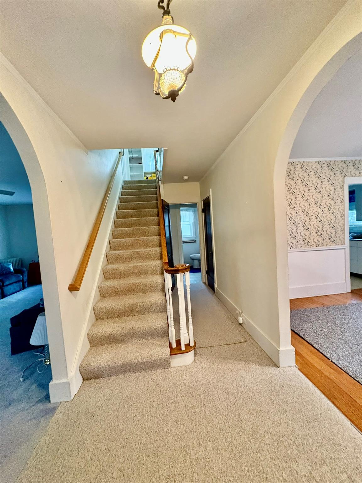 123 Rockland Road Roscoe, NY 12776 - Photo 15 of 31 Staircase featuring carpet, arched walkways, crown molding, and baseboards
