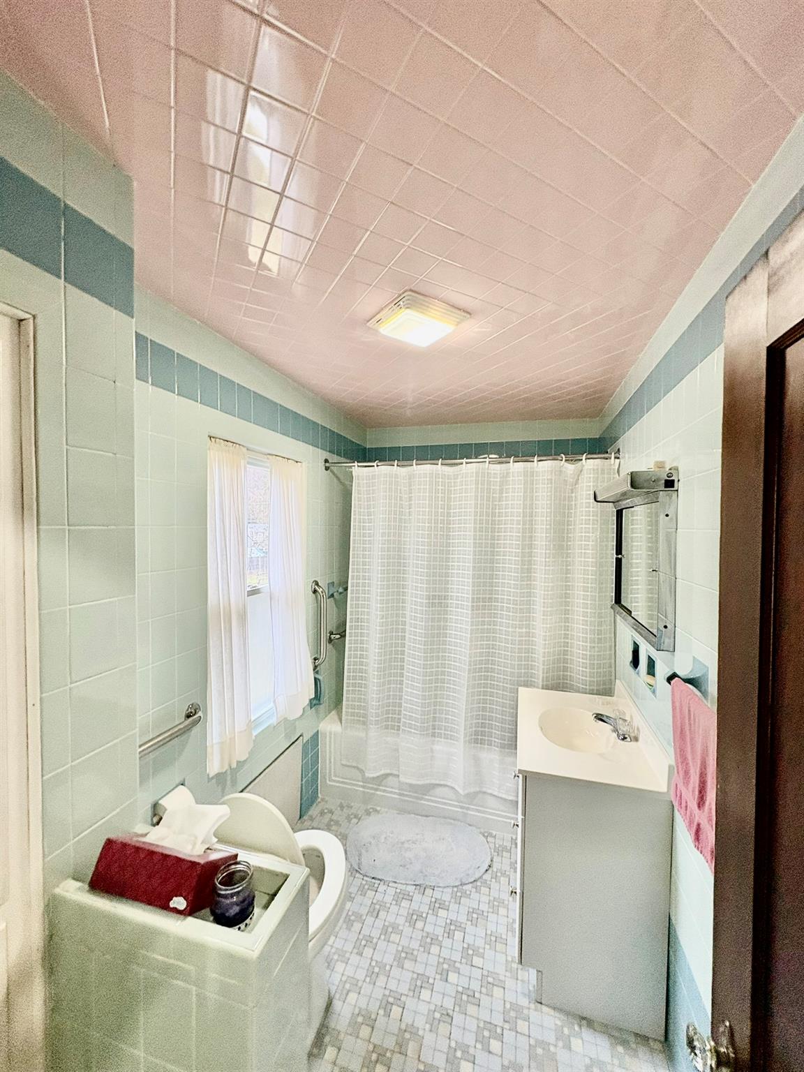 123 Rockland Road Roscoe, NY 12776 - Photo 19 of 31 Bathroom featuring toilet, shower / bath combo, tile walls, and vanity